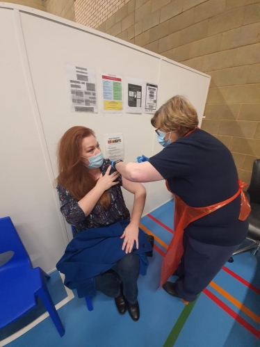 Jane receiving her vaccine