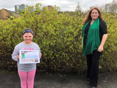 Jane presenting the certificate to Faith