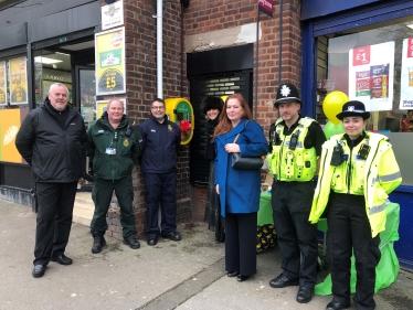 Jane (centre) at the unveiling of the defibrillator